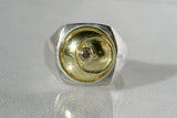 Silver signet ring with 18kt gold top featuring a champagne diamond and a granulated moon motif.