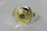 Silver signet ring with 18kt gold top featuring a blue diamond and a granulated moon motif. The rings sides have champagne diamonds